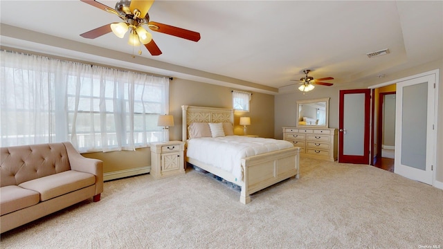 bedroom featuring baseboard heating, ceiling fan, and light carpet