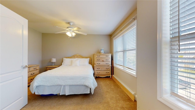 bedroom with ceiling fan and light carpet