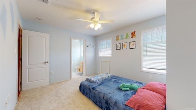 carpeted bedroom with ceiling fan and connected bathroom