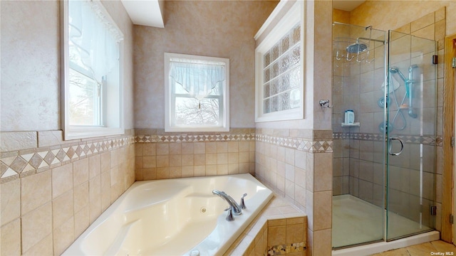 bathroom with a whirlpool tub and a stall shower