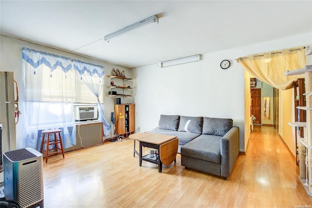 living room with cooling unit and wood-type flooring