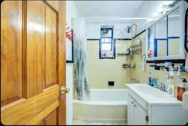 bathroom featuring vanity and shower / bath combination with curtain