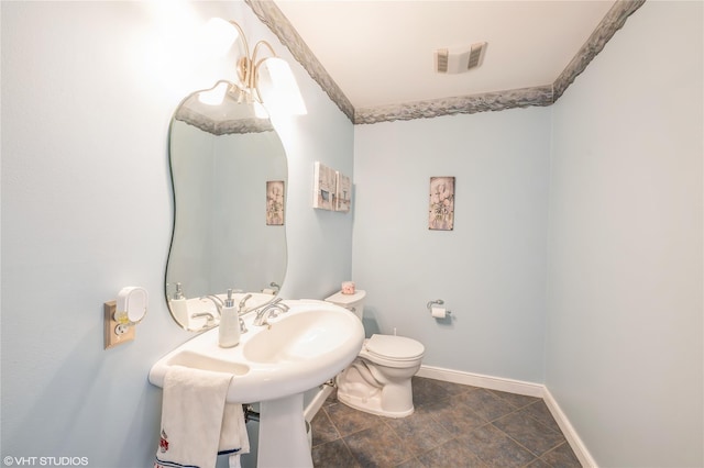 bathroom featuring toilet, baseboards, and visible vents