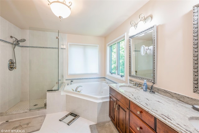 bathroom featuring double vanity, tile patterned floors, a garden tub, a shower stall, and a sink