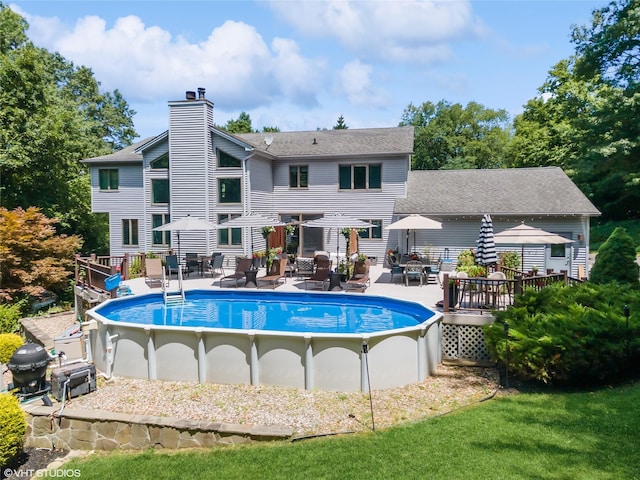 outdoor pool with a deck and outdoor dining space