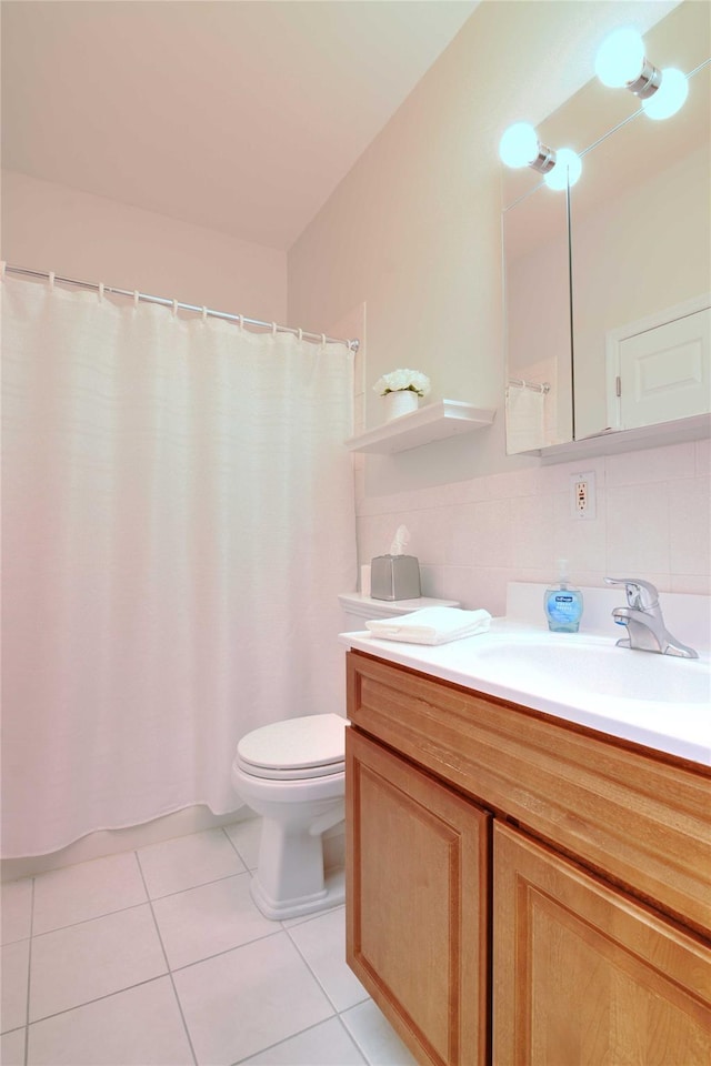 bathroom with tile patterned flooring, vanity, and toilet