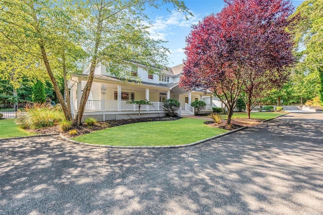 view of front of property with a porch and a front lawn