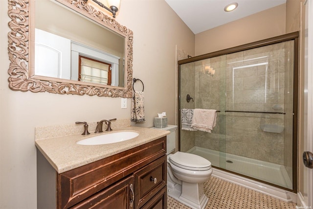 bathroom featuring vanity, tile patterned floors, a shower with door, and toilet