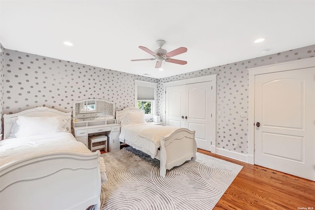 bedroom with light hardwood / wood-style floors, a closet, and ceiling fan