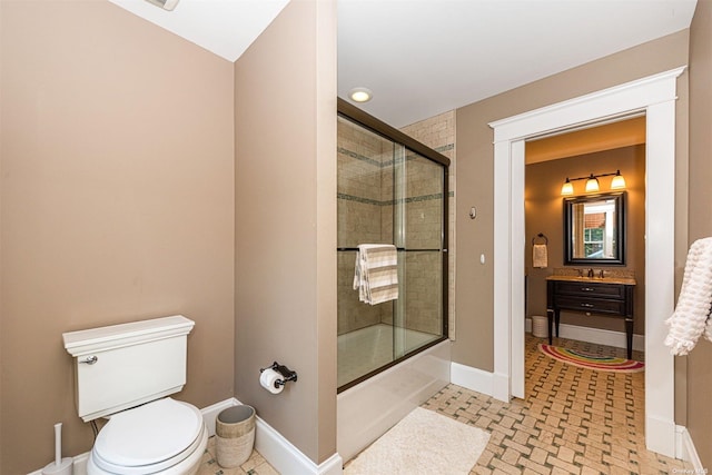 full bathroom featuring bath / shower combo with glass door, sink, and toilet