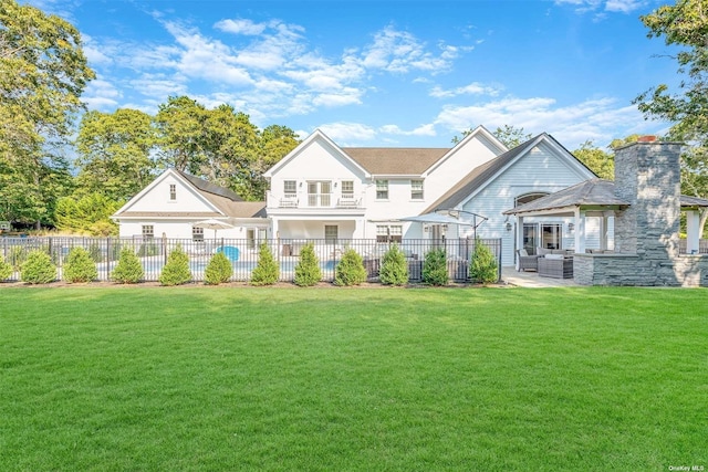 rear view of property featuring a yard