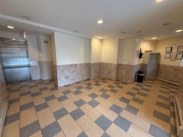 empty room featuring tile walls and baseboard heating