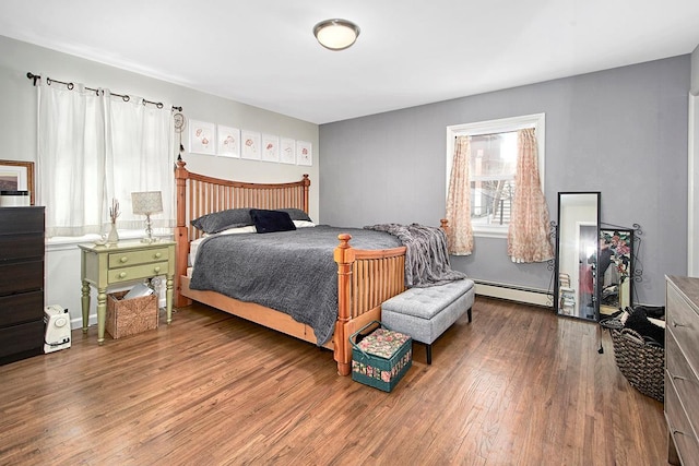 bedroom with hardwood / wood-style flooring and a baseboard radiator