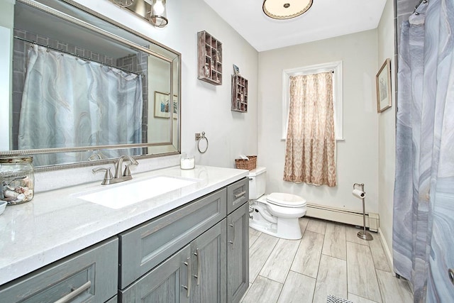 bathroom featuring baseboard heating, vanity, and toilet