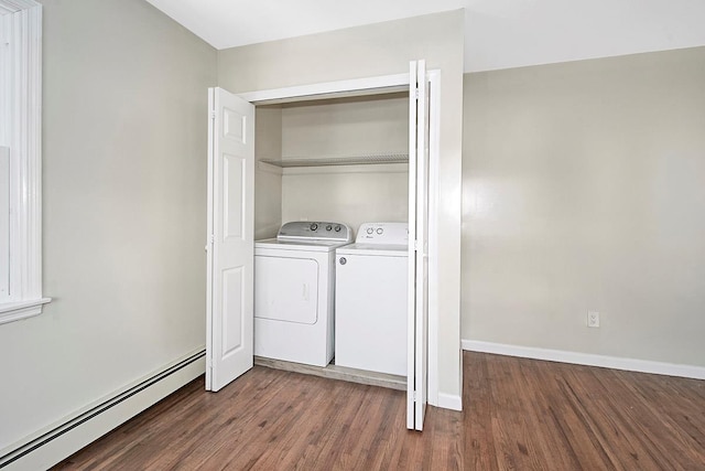 washroom featuring dark wood-type flooring, a baseboard radiator, and independent washer and dryer