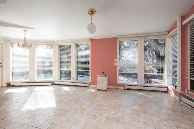 interior space with a chandelier and a baseboard heating unit