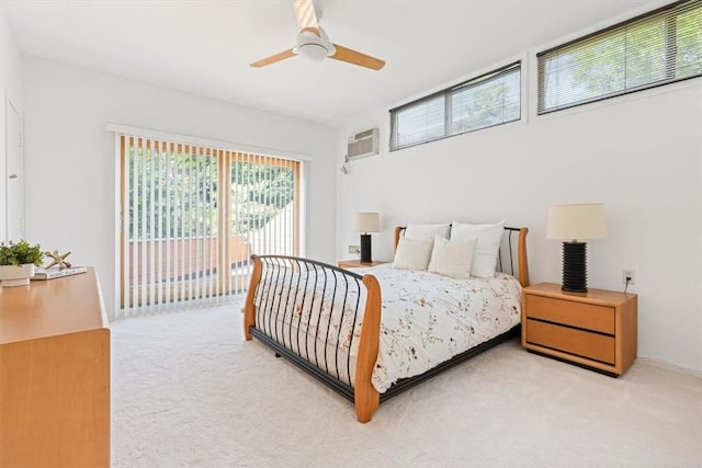 bedroom with an AC wall unit, carpet flooring, access to outside, and ceiling fan