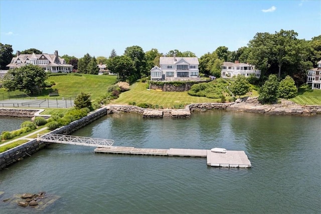 exterior space featuring a water view and a lawn