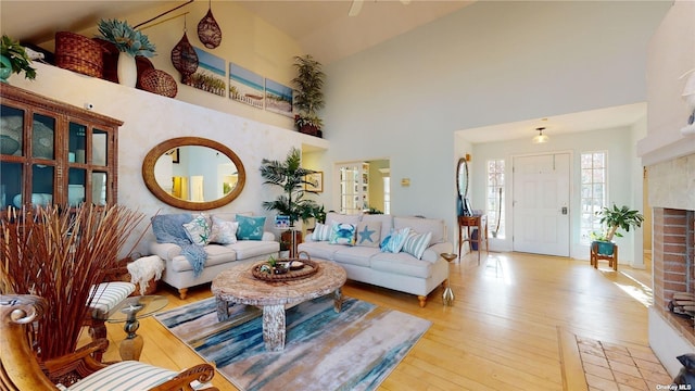 living room featuring a high ceiling and light wood-type flooring