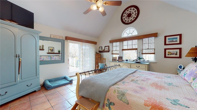 tiled bedroom with ceiling fan and high vaulted ceiling