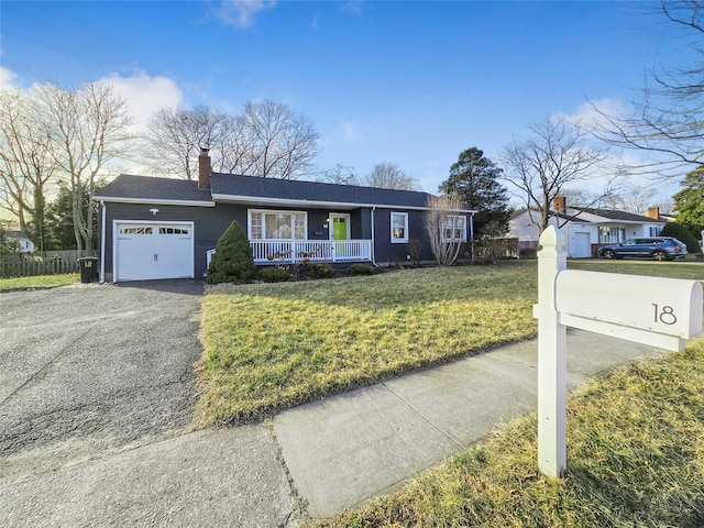 ranch-style home featuring a garage, a front yard, and a porch