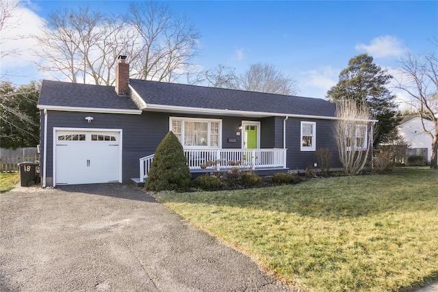 ranch-style home with a garage, covered porch, and a front lawn