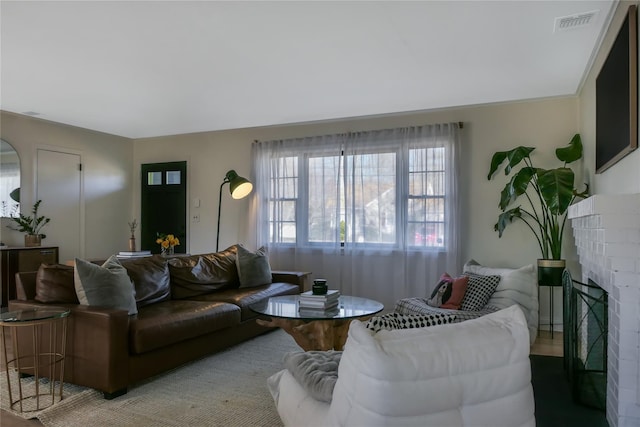 living room with a brick fireplace