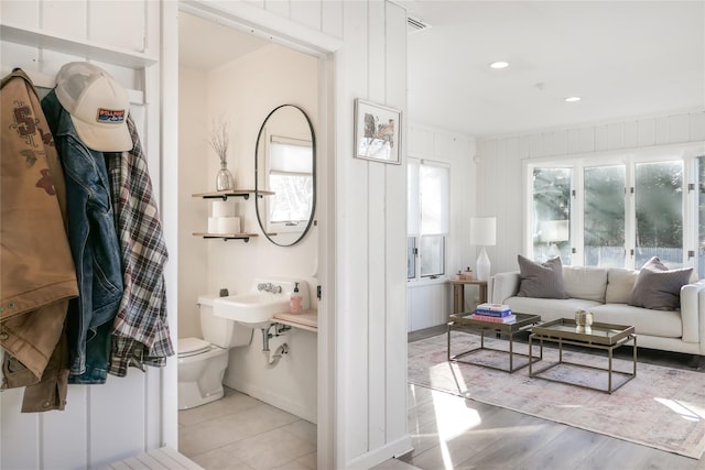 bathroom with ornamental molding and toilet