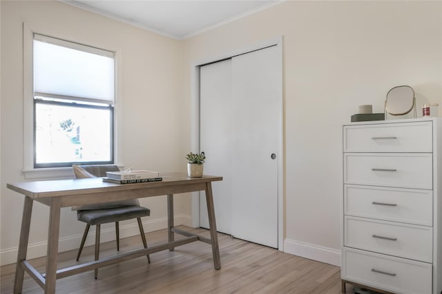 office space with ornamental molding and light wood-type flooring