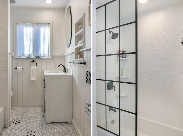 bathroom featuring vanity, tile patterned flooring, and combined bath / shower with glass door