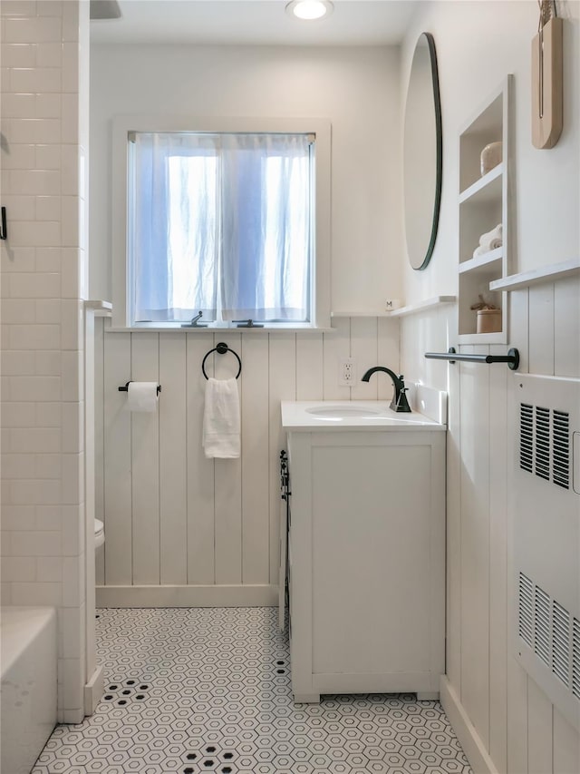 bathroom with vanity and a tub