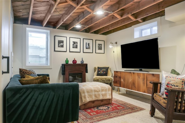 carpeted living room with beamed ceiling and a wealth of natural light