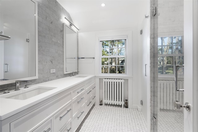 bathroom featuring radiator and vanity