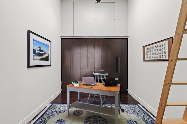 office space with dark hardwood / wood-style flooring