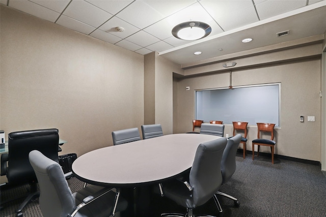 carpeted office with a drop ceiling