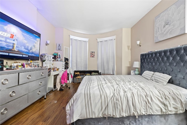 bedroom with dark hardwood / wood-style flooring