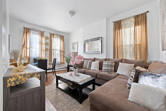 living room with hardwood / wood-style floors and a baseboard heating unit