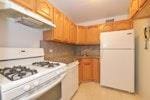 kitchen featuring white appliances and decorative backsplash