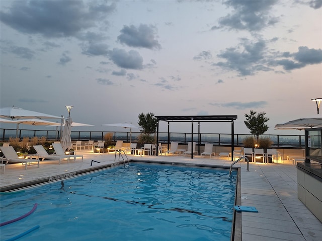 view of pool at dusk