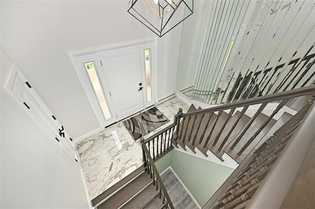 entrance foyer with an inviting chandelier and a high ceiling