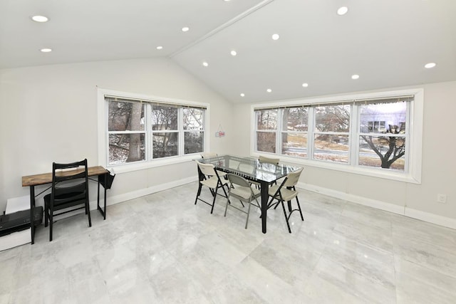 dining room with a healthy amount of sunlight and vaulted ceiling