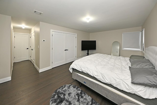 bedroom featuring dark hardwood / wood-style floors and a closet