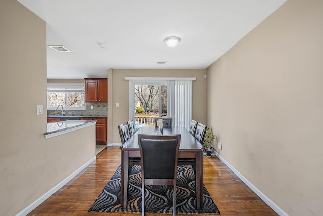 dining room featuring sink and dark hardwood / wood-style floors