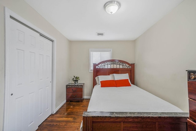 bedroom with dark hardwood / wood-style flooring