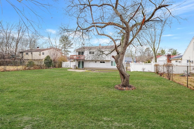 view of yard with a balcony