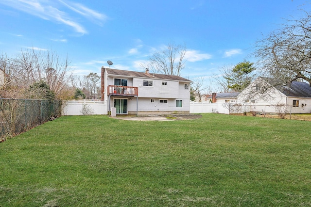 back of property with a lawn and a patio area