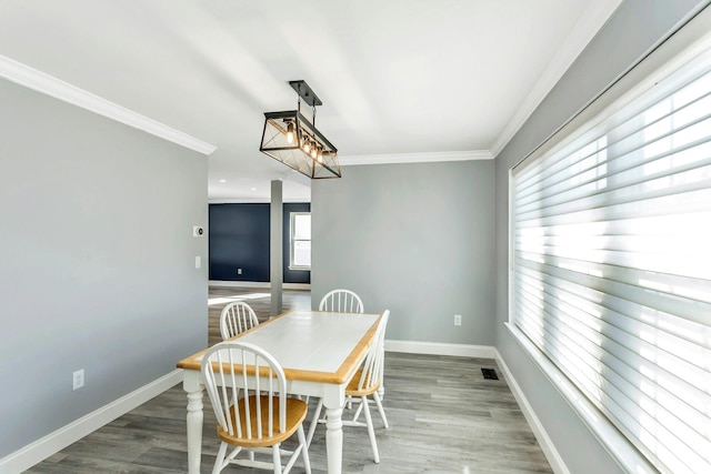 dining room featuring crown molding and wood-type flooring