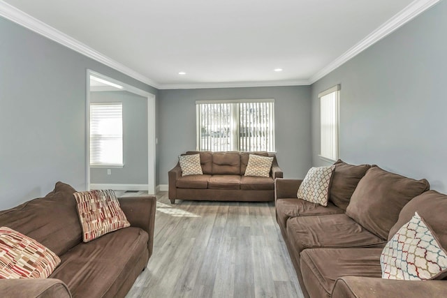 living room with crown molding and light hardwood / wood-style floors