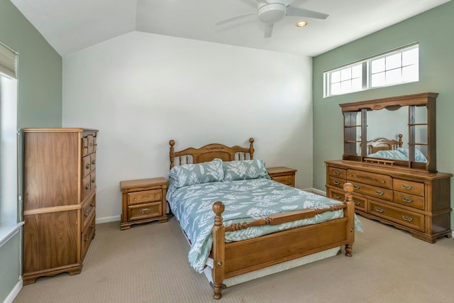 bedroom featuring ceiling fan, vaulted ceiling, and light carpet