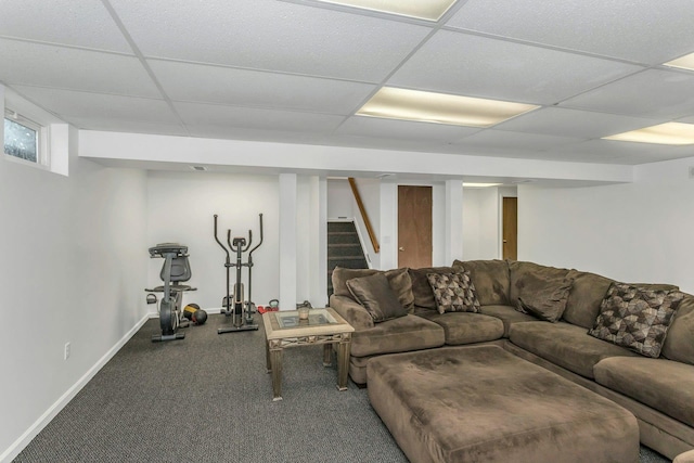 living room with a drop ceiling and carpet flooring